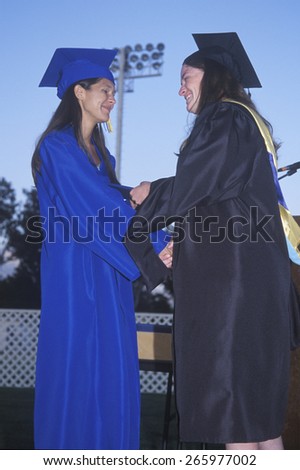 Teacher congratulates a high school graduate receiving her diploma, Nordhoff High School, Ojai, CA