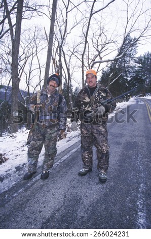 Deer hunters with guns and camouflageÃ?Â?? pursue deer in New Jersey state park in winter