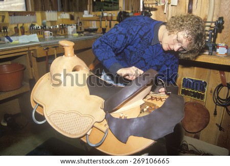 A woman making a custom made saddle, Three Fork Saddelry, MT