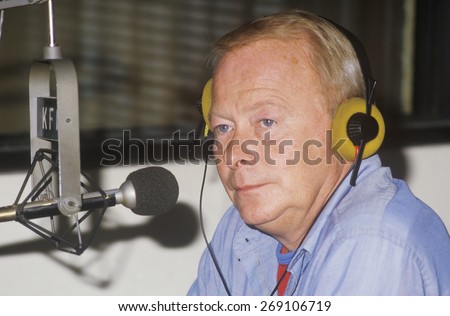 Radio disc jockey for station KFI in his studio, Los Angeles, CA