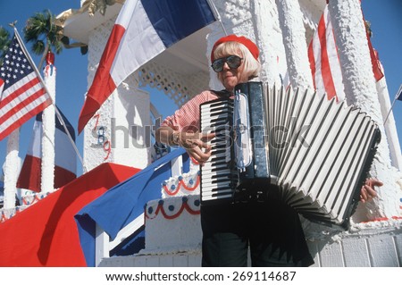 A female accordion player performing at the French Revolution Bicentennial Celebration, Hollywood Park, CA