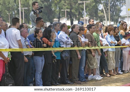 Crowd of people outside behind yellow police ribbon, CSU- Dominguez Hills, Los  Angeles, CA