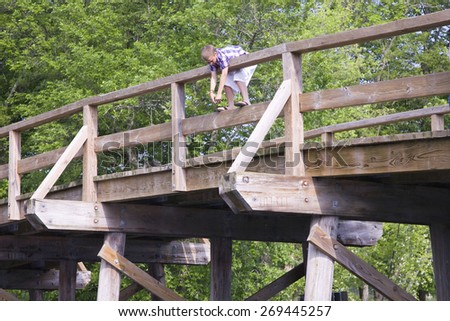 Young boy stands at top of the Old North Bridge, Concert Mass, site of the first American victory in the Revolutionary War on April 19, 1775