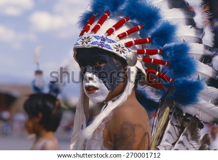 Native American boy with feathered headdress, Corn Dance ceremony, New Mexico