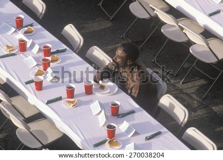 One black man eating Christmas desert at homeless shelter, Los Angeles, California