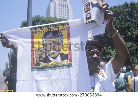 Man holding up Nelson Mandela t-shirt, Los Angeles, California