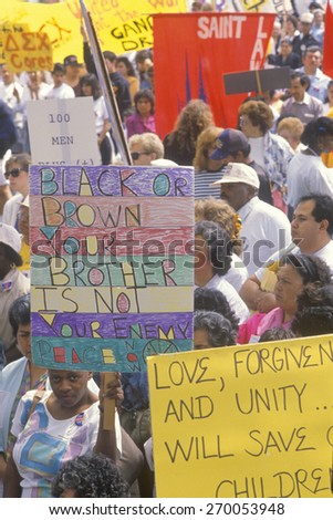 Activists holding signs during anti-violence demonstration, East Los Angeles, California