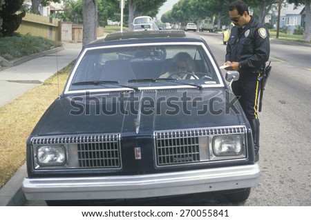 Traffic police officer ticketing female driver, Santa Monica, California