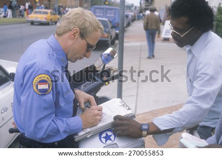 Police officer writing ticket, New Orleans, Louisiana