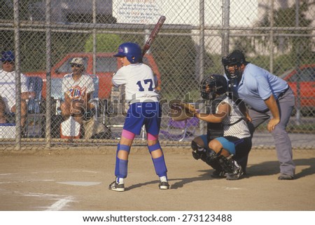 Girl preparing at bat with umpire, Girls Softball game, Brentwood, CA