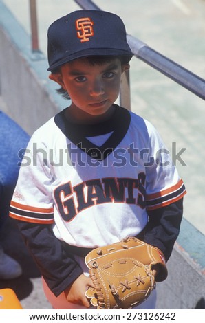 Young baseball fan with Giants jersey posing at Candlestick Park, San Francisco, CA