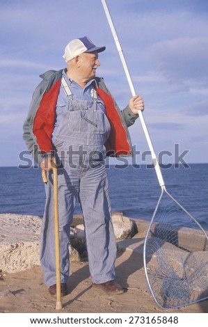 Older Fisherman with net, Lake Superior, WI