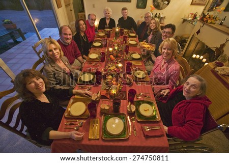 Guests at an elegant Thanksgiving dinner party