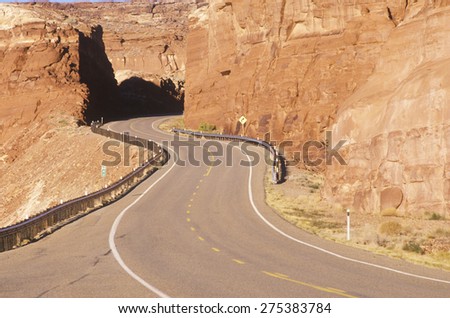 A winding road curves through red rock in the desert southwest USA
