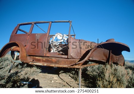 A deserted car with a cow skeleton driving in the Great Basin National Park, Nevada
