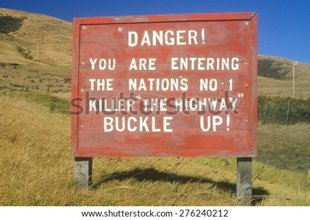 Danger road sign warning to buckle up!