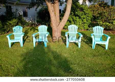Turquois lawn chairs in sunset light, near Maine & New Hampshire border
