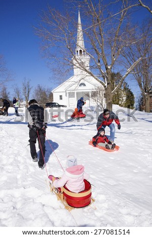 Sleigh riding in fresh snow in front of New England Church, in town of Harvard, Ma., New England, USA