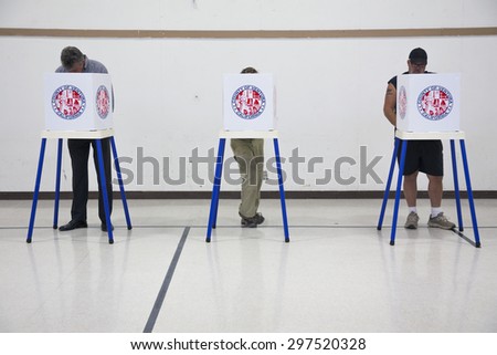 Oak View, California, USA, November 4, 2014, citizen votes in election booth polling station in gymnasium