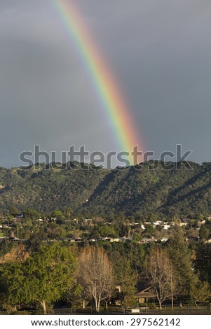 Oak View, California, USA, March 1, 2015, full rainbow over rain storm over mountains Ojai Valley