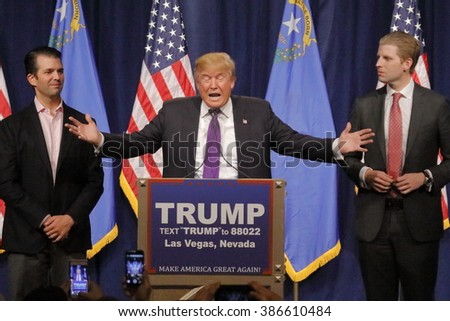 LAS VEGAS, NV - FEBRUARY 23, 2016: Donald Trump is flanked by sons Eric (Right) and Donald Jr. (Left) during Mr. Trump\'s victory speech after Nevada caucus, Las Vegas, NV at Treasure Island Casino and Hotel