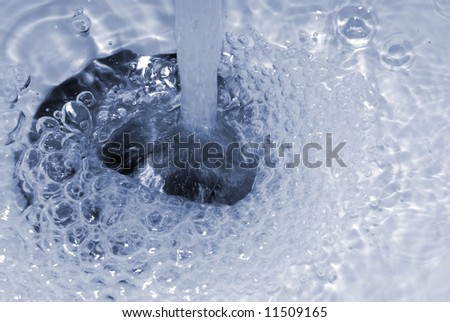 Close up shot of water going down a drain