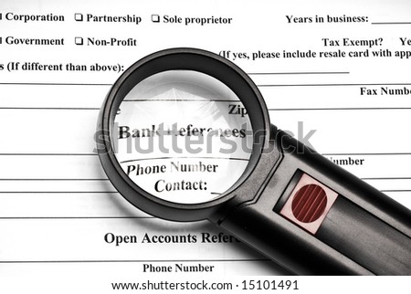 Magnifying glass on top of bank reference document