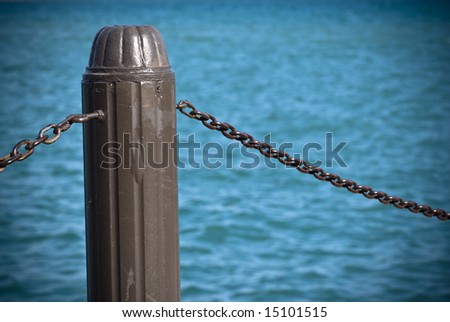 Post and chain with a blue lake background