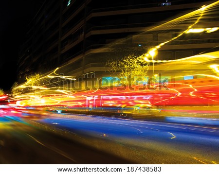 Traffic lights at night, shoot at low speed to get that blurred and trail effect. It\'s intentionally blurred to get the speed light effect