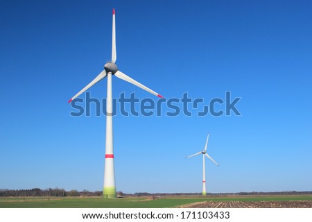 Two windmills on a cloudless, sunny day