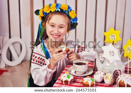 pretty girl smiling with  big  easter cake wreath