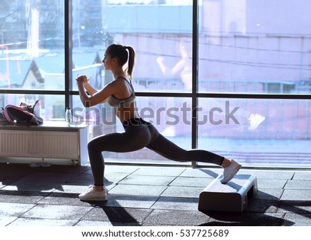 Beautiful athlete woman exercising in fitness club.
