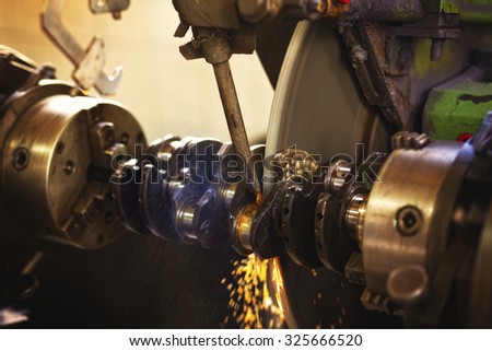 Closeup shot of working industrial machine. This machine is used for the treatment of automotive and marine and boat engines. Visible grain. Short depth of field and selective focus.
