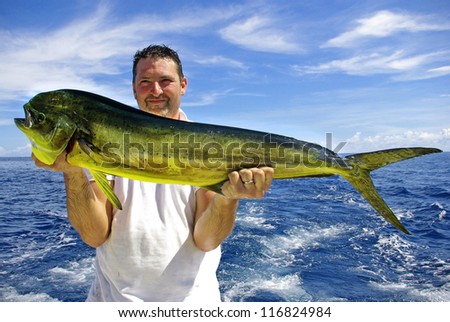 Lucky  fisherman holding a beautiful dolphin fish