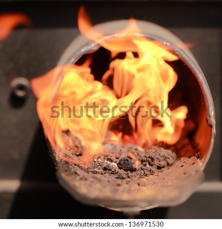 flame of fire out of a metal pipe