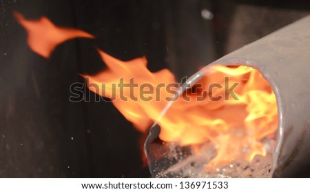 flame of fire out of a metal pipe