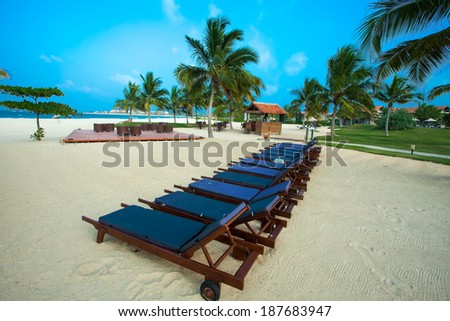 sunbeds under a parasol on the beach of the Indian Ocean Pasikuda.