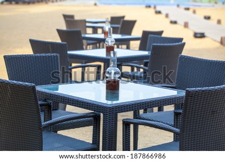 restaurant tables and chairs on the shore of the Indian Ocean.The popular beach of the island of Sri Lanka Pasikuda