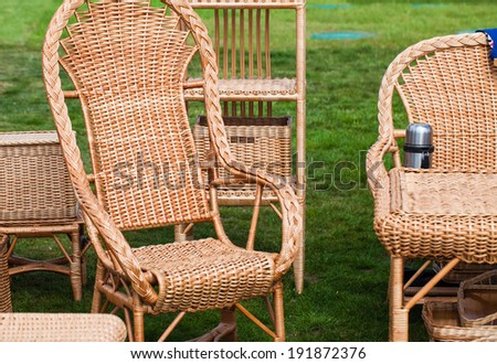wicker rocking chair and furniture on green grass