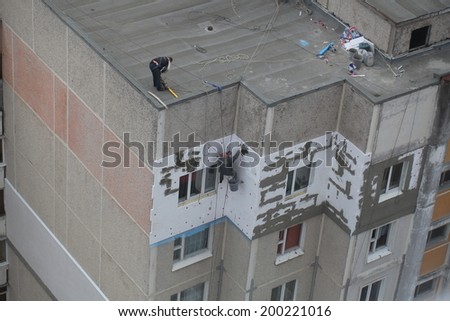 Builders insulation plaster on the wall, hanging on a clothesline. Belarus, Minsk, 20 June 2014