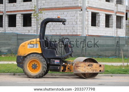 construction machinery in the background of high-rise building. road construction equipment. rink