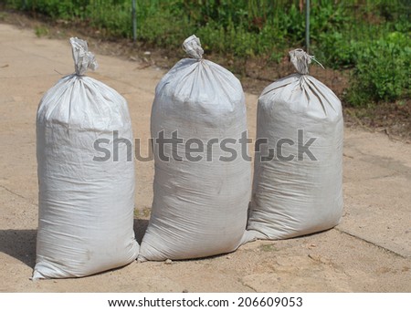 large white bag with building materials, sand, cement, waste