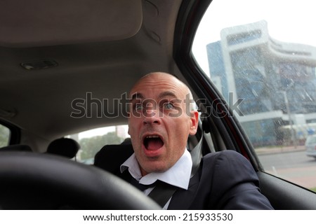 frightened man behind the wheel of car