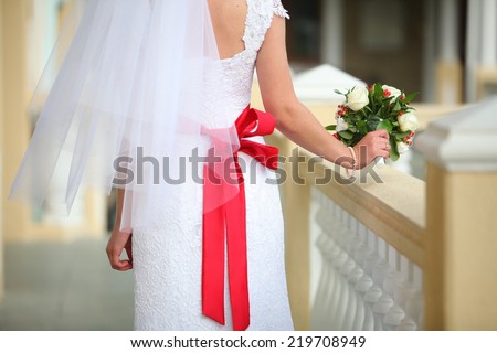 bouquet of flowers in the bride\'s hands rear view