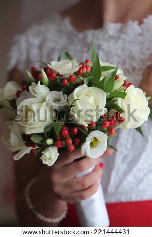 Bride in wedding dress with a bouquet in the hands of