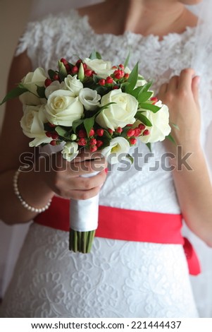 Bride in wedding dress with a bouquet in the hands of