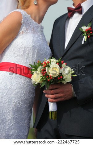 the bride and groom with a bouquet of flowers