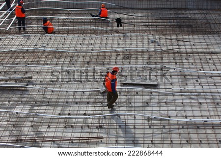 workers in the construction of the building foundation. laying warm floors. Belarus, Minsk, Oktober,8,2014