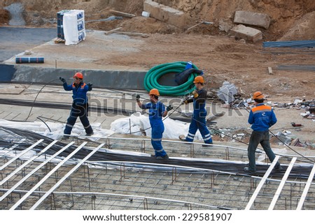 Renaissance builders stretch metal wires under the foundation. The concrete foundation of the hotel building. Belarus,Minsk,Novem ber,1,2014