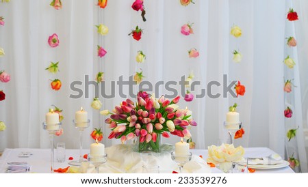 Bouquet of red and yellow tulips on a festive table. Wedding decoration.